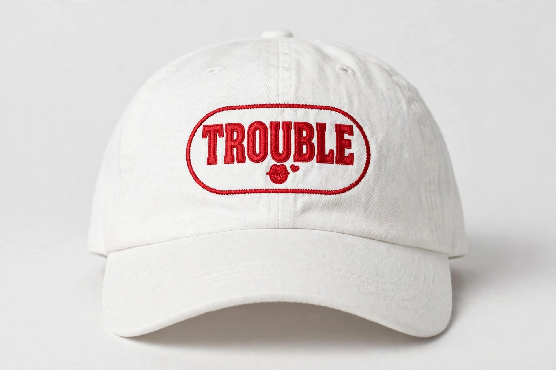 Trouble Hat — white dad hat with red TROUBLE embroidery